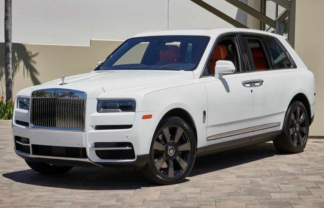 White Rolls-Royce Cullinan luxury SUV parked at mansion