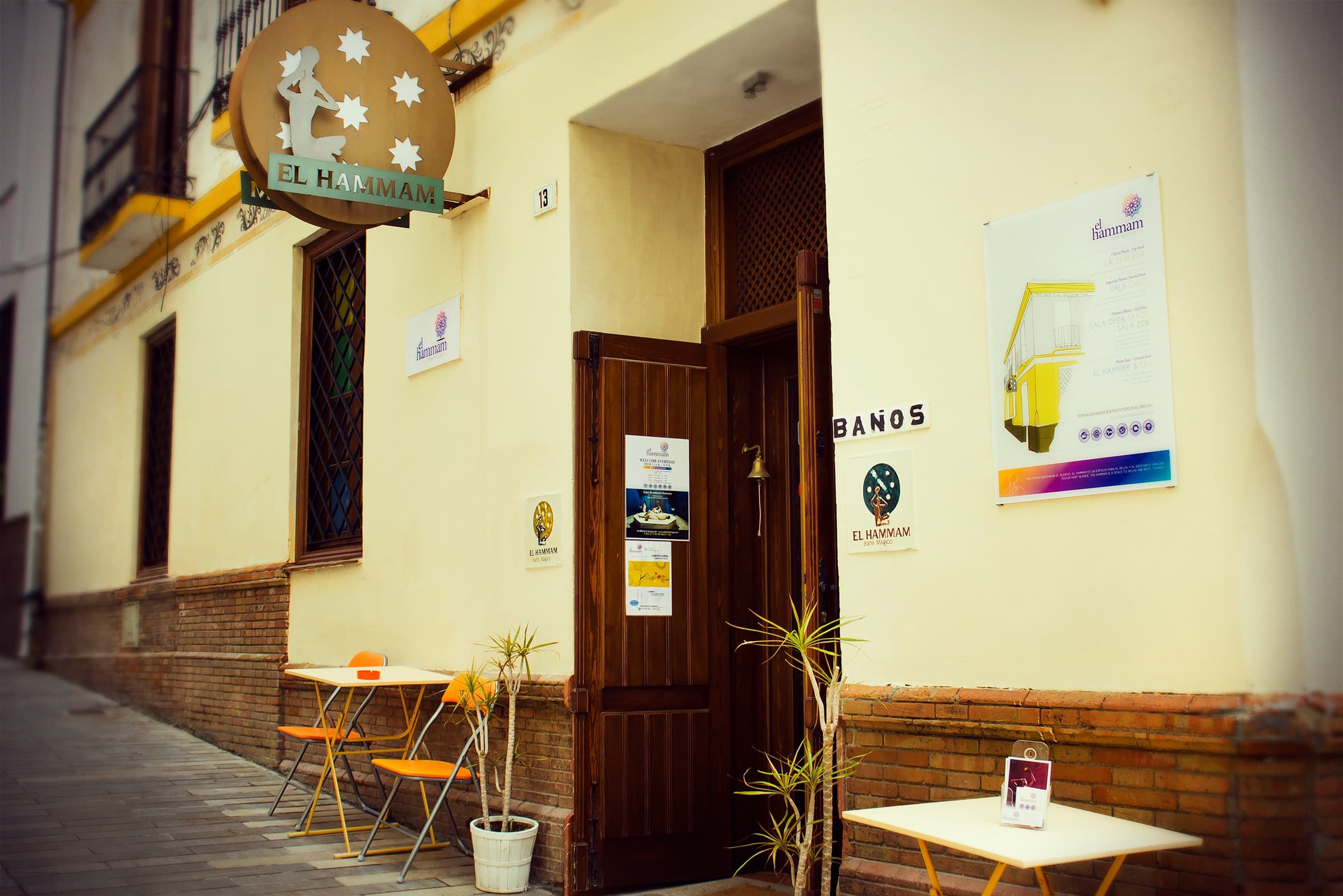 Exterior of traditional hammam building with outdoor café seating
