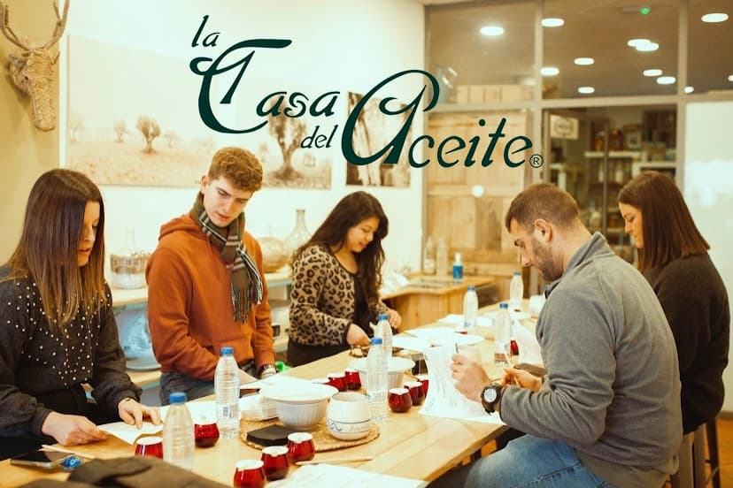 Olive oil tasting indoors at La Casa del Aceite shop, group sampling