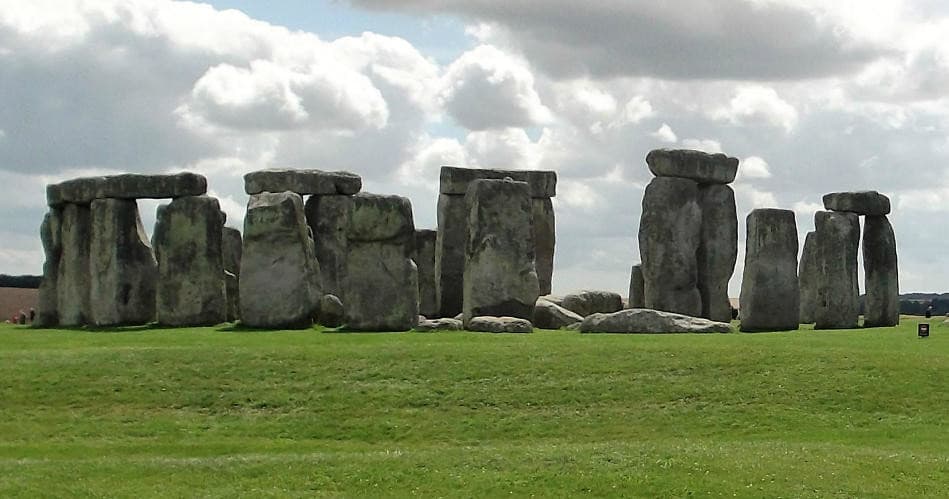 Visitors viewing Stonehenge megaliths on Salisbury Plain England