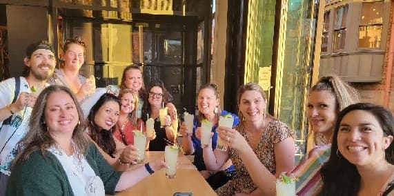 Group enjoying cocktails at a lively indoor restaurant table