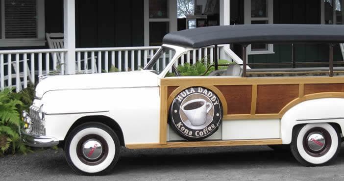 Vintage woody truck parked outside Kona coffee farm in Hawaii