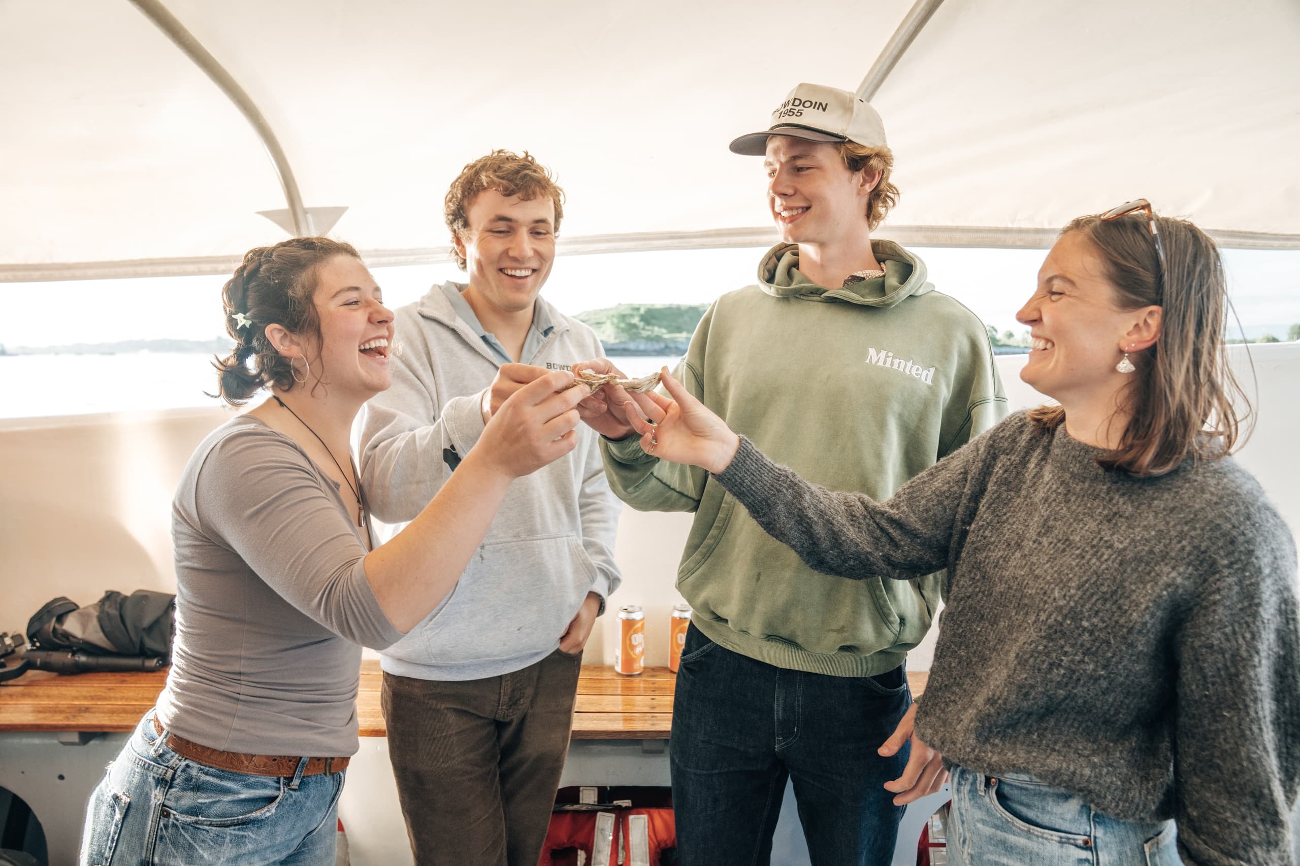 Friends celebrating on a sheltered boat deck near harbor