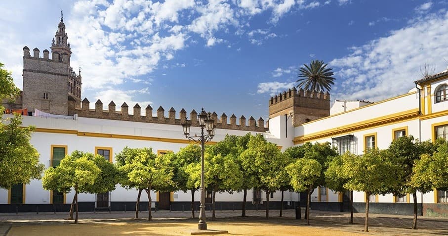 Alcázar courtyard lined with orange trees and arches
