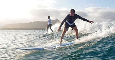 Surfer riding a clean blue wave in open ocean action