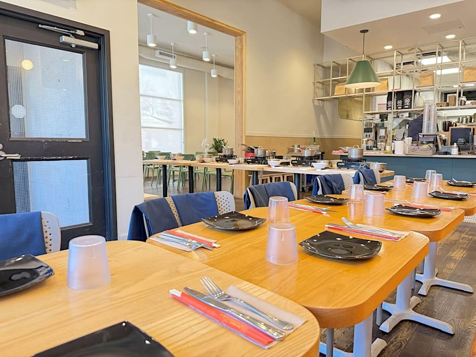 Bright casual dining room with wooden tables set for guests indoors