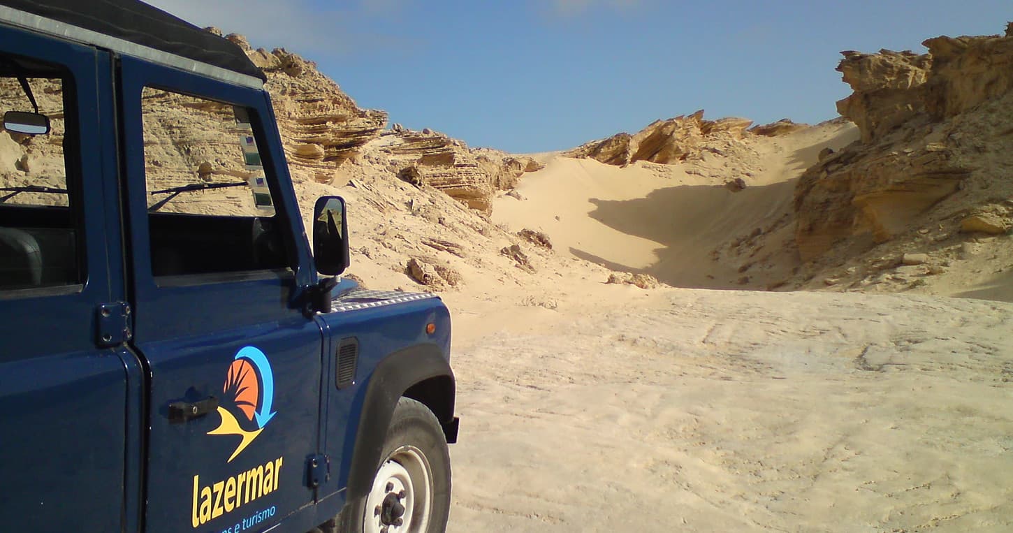 Off-road 4x4 vehicle in desert dunes for guided jeep tours
