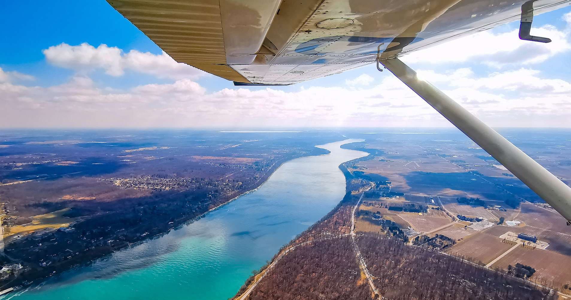 Wing-view aerial over river and countryside scenic flight