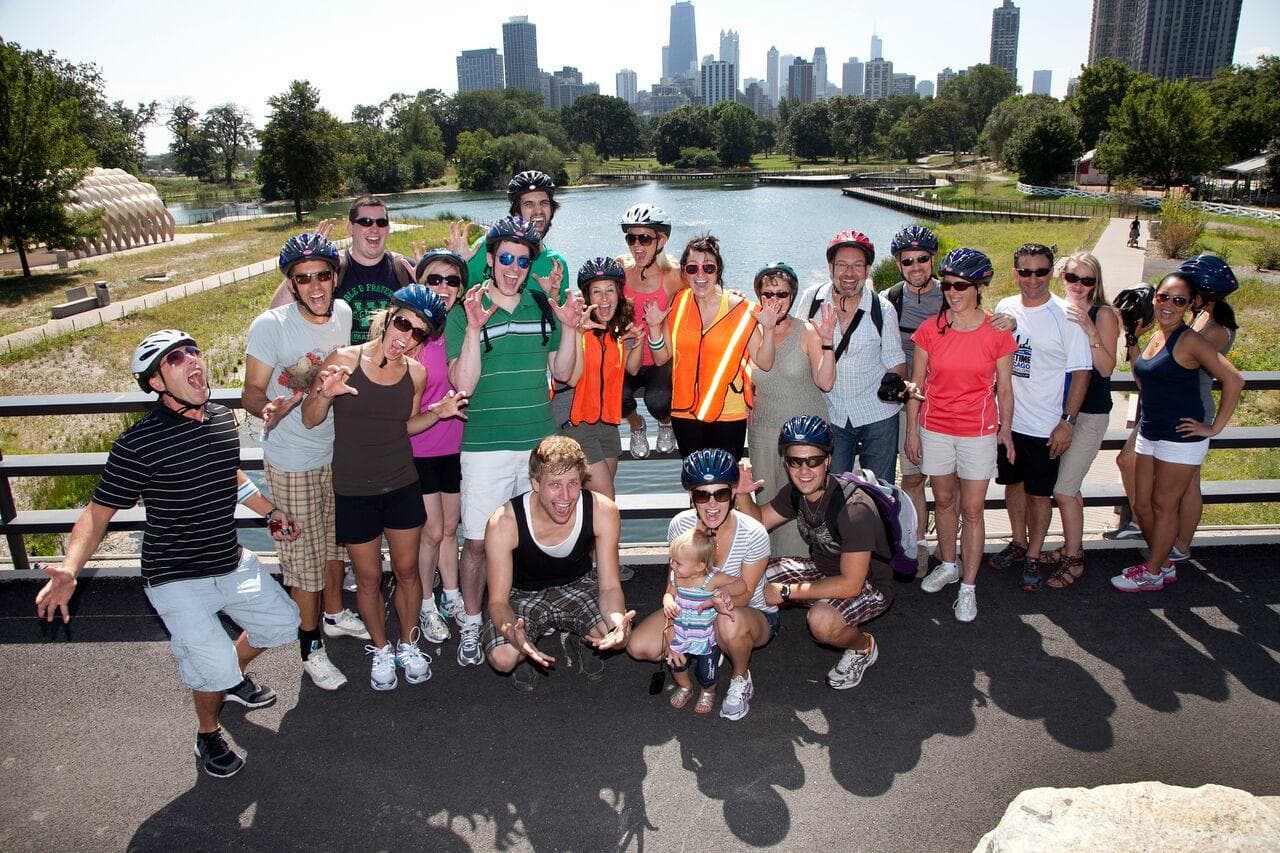 Group of cyclists and walkers posing by Chicago skyline park
