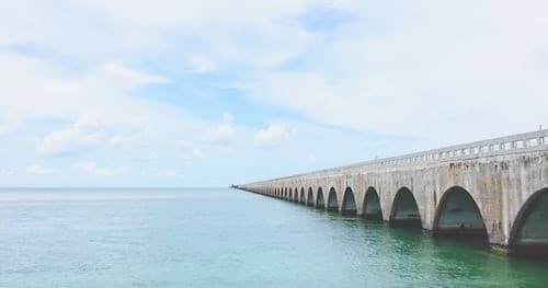 Historic long bridge stretching over turquoise sea in Florida Keys