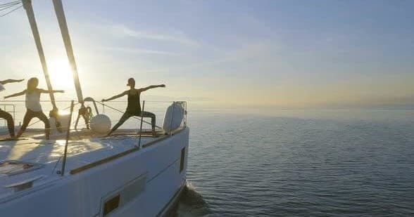 People on yacht deck enjoying calm sunrise cruise on sea