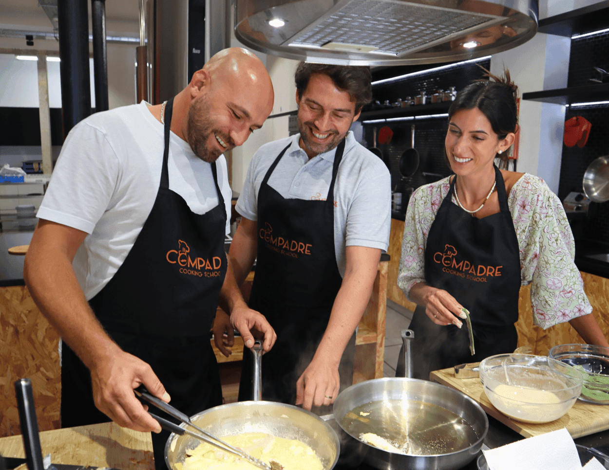Group cooking class chefs stirring pans in indoor kitchen
