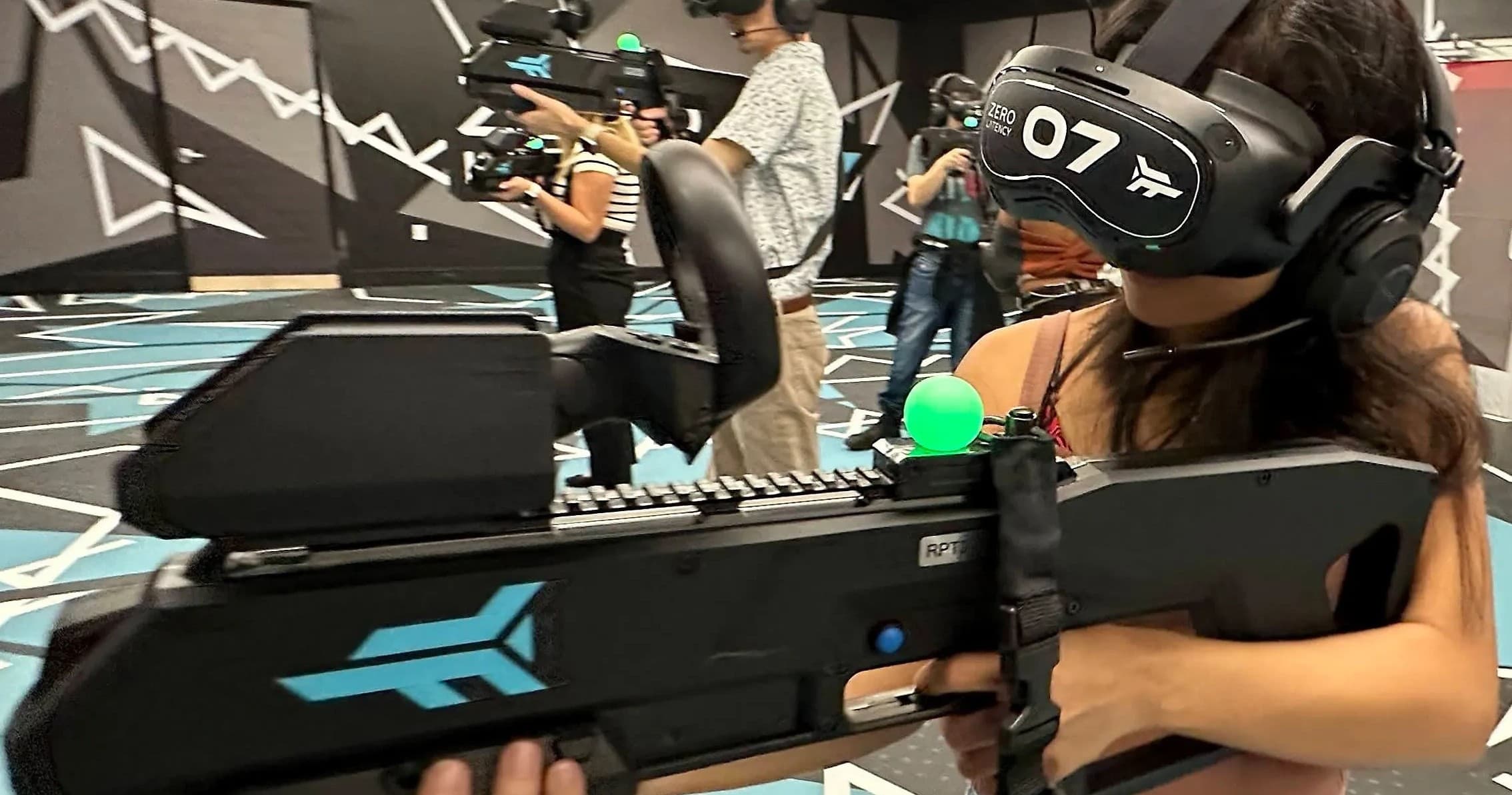 Gamer aiming VR rifle in virtual reality arena indoors