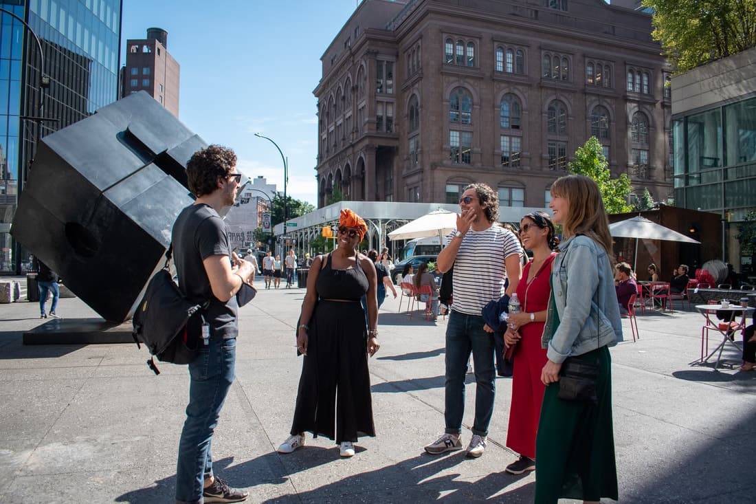 Guided walking tour group near public art plaza in Manhattan