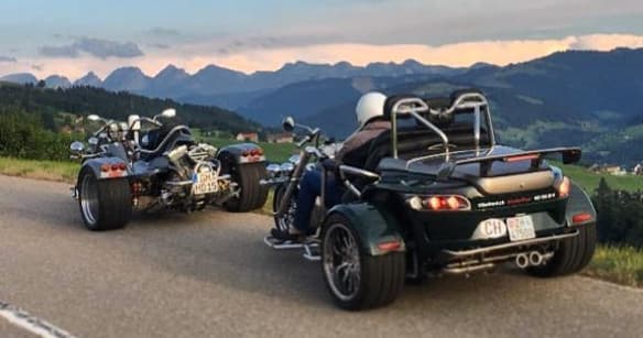 Two trikes cruising scenic mountain road at sunset tour