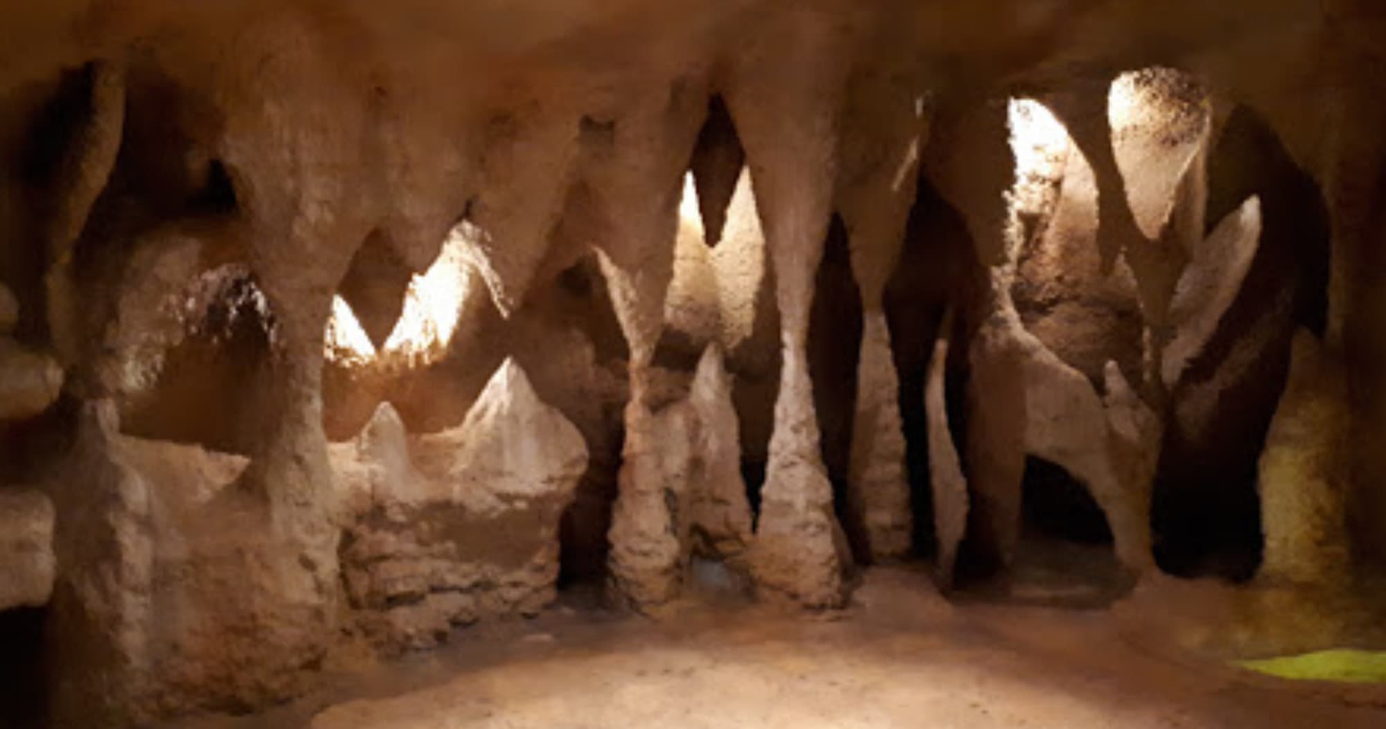 Underground limestone cave formations and narrow cavern passage