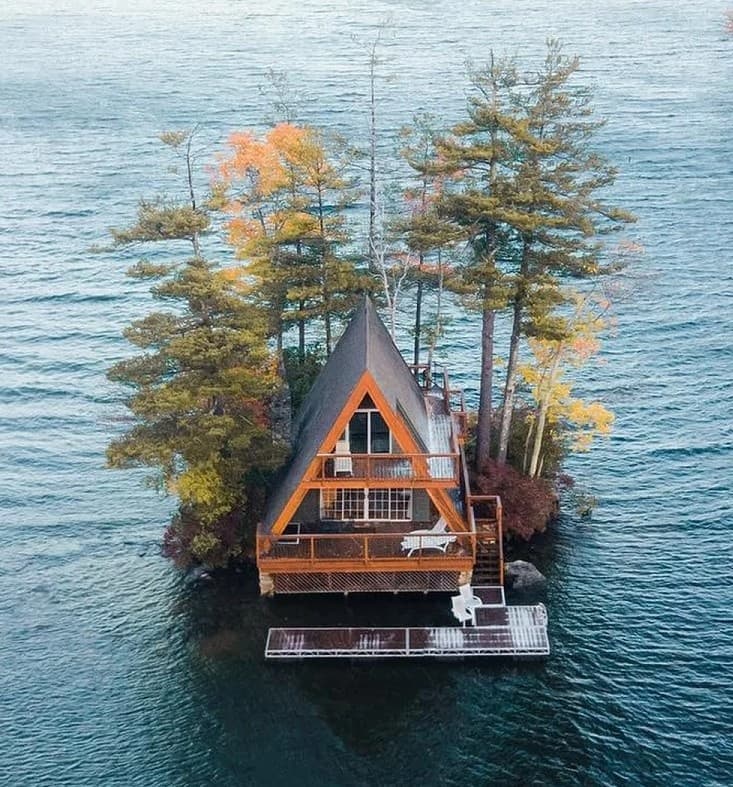 A-frame cabin on a tiny forested island in a lake, secluded retreat