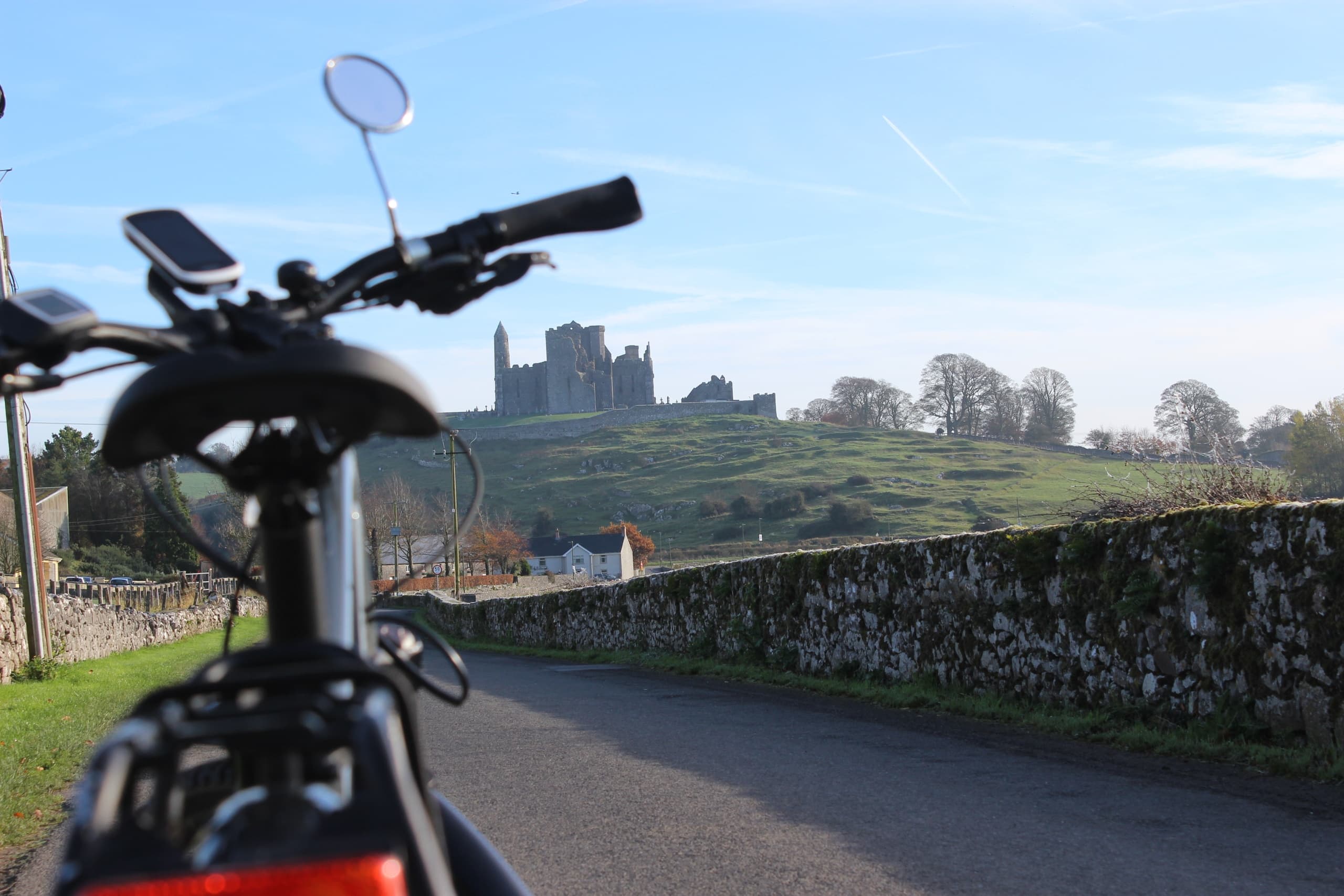 Motorcycle ride past medieval castle on scenic coastal road