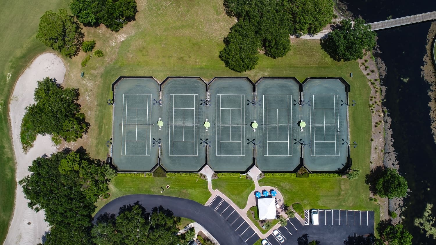 Aerial view of outdoor tennis courts in park setting