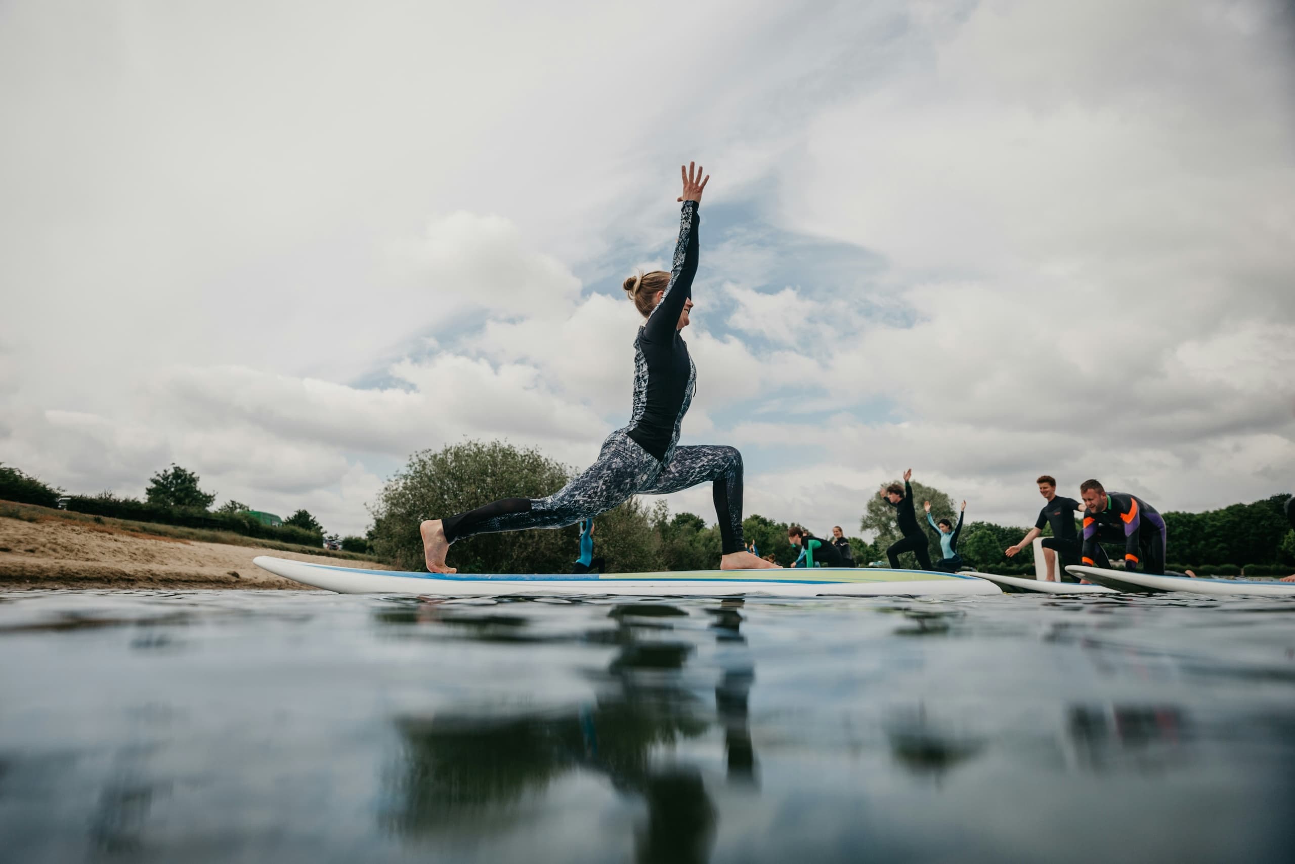 Stand-up paddleboard yoga session on shallow coastal water