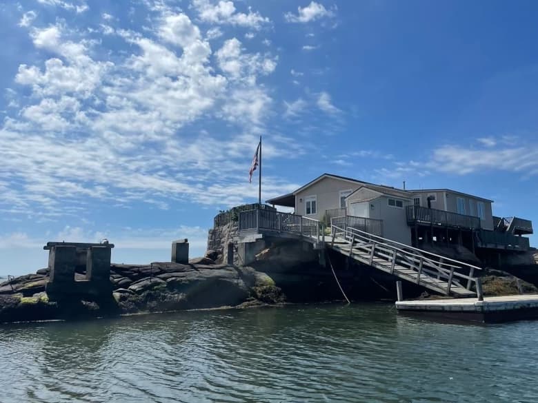 Panoramic shoreline of Thimble Islands with blue sky and water