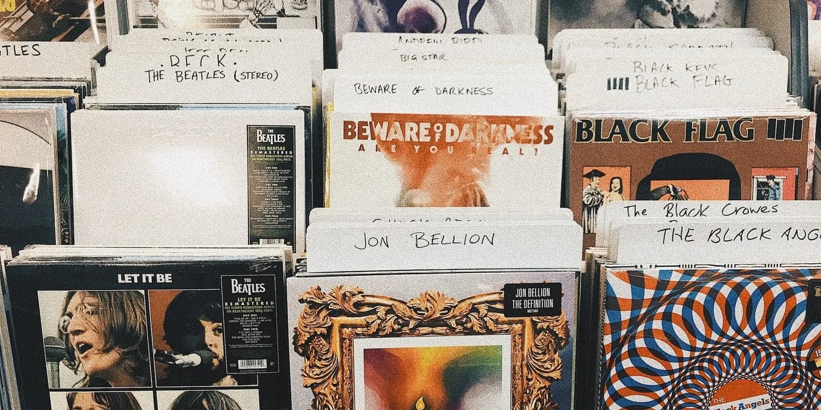 Vintage vinyl records display inside independent record shop, browsing