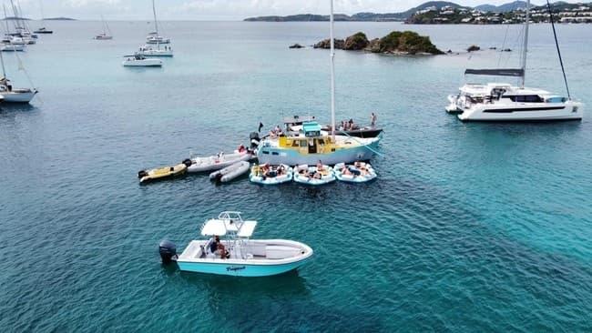 Aerial view of anchored yachts and turquoise bay near islets