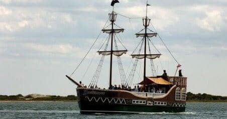 Tall ship sailing off coast on scenic harbor cruise experience