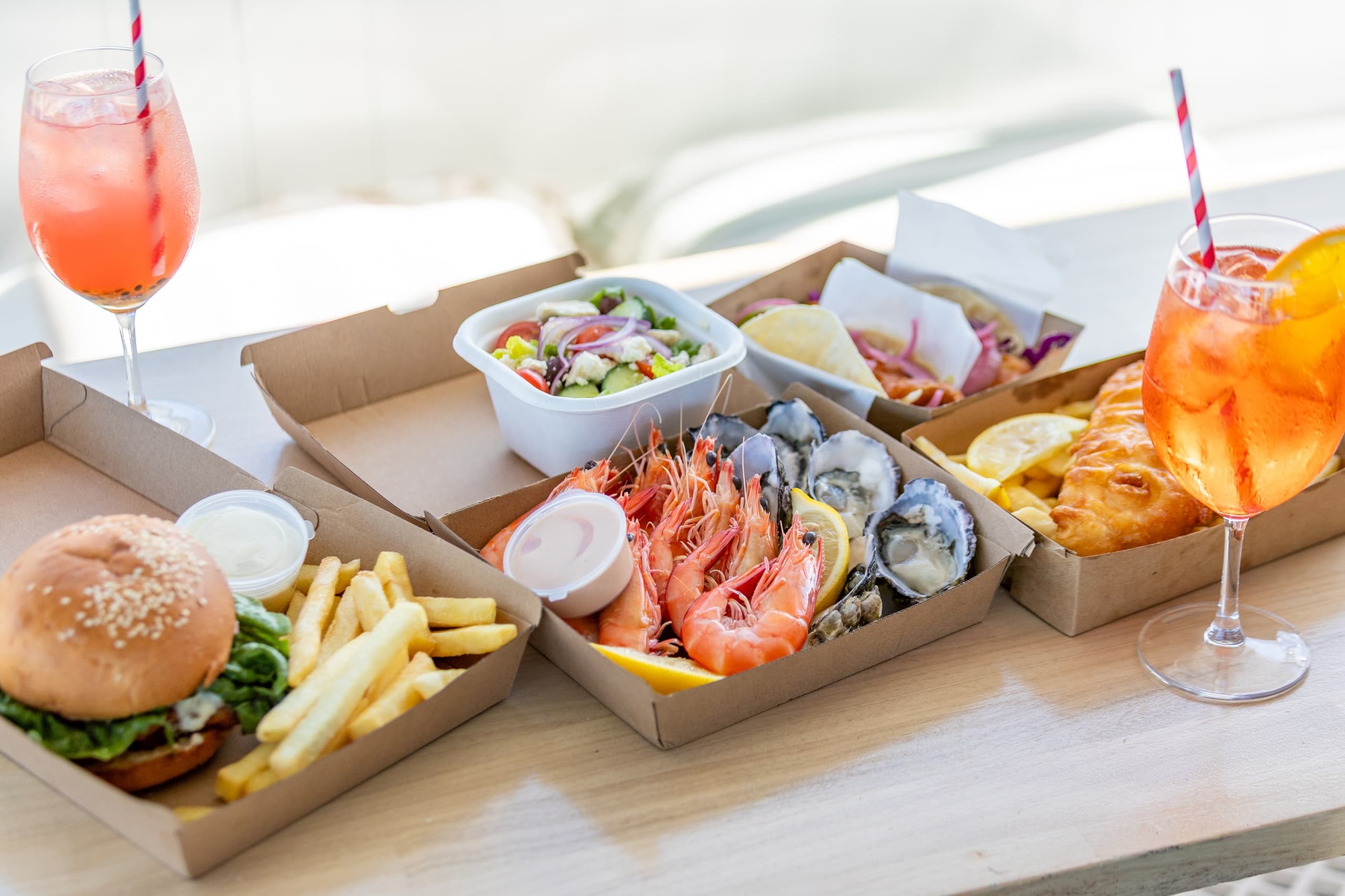 Seaside picnic boxes and drinks served aboard tour boat at Noosa