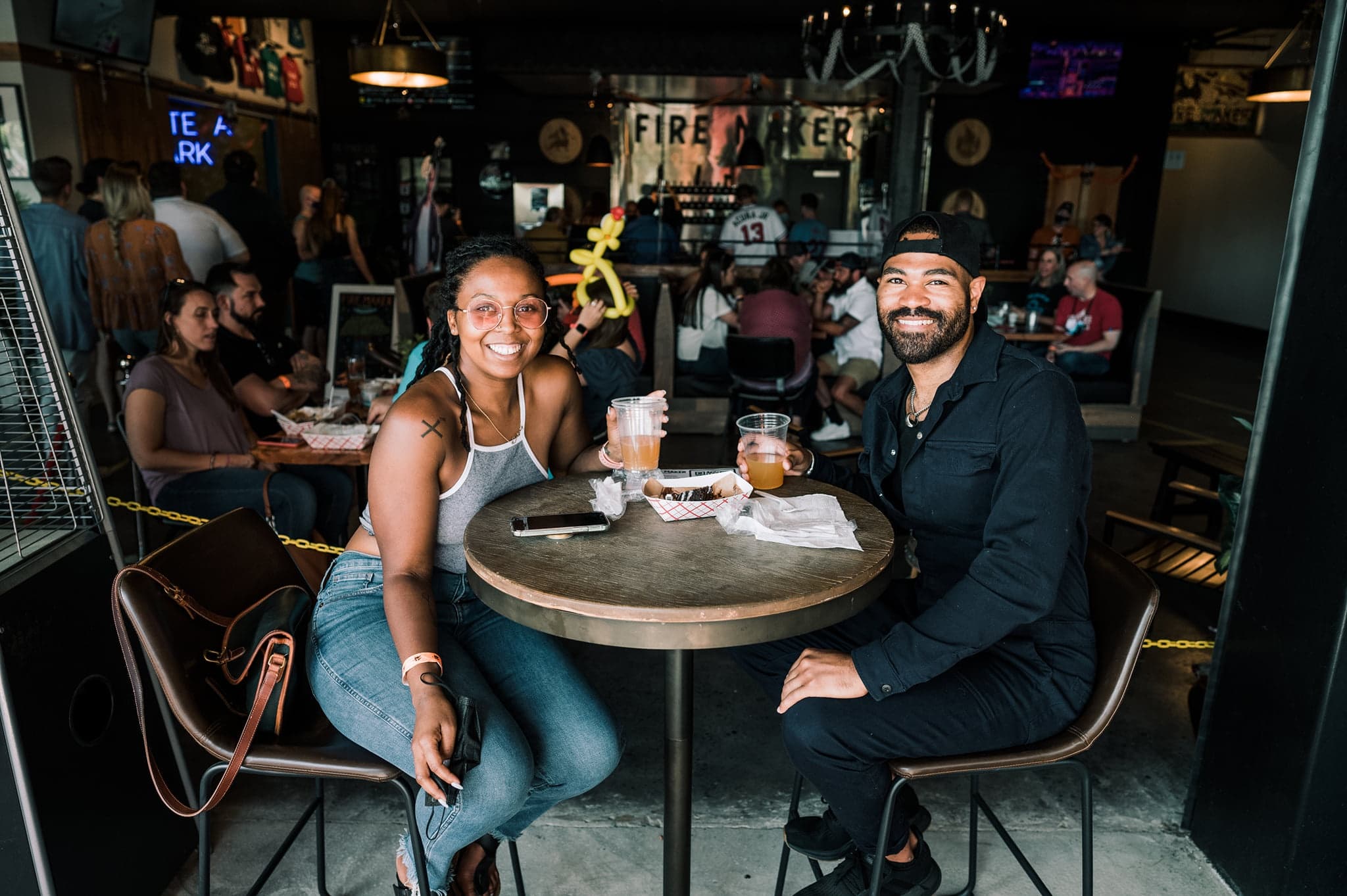 Friends enjoying craft beers at cozy Atlanta brewery tasting table
