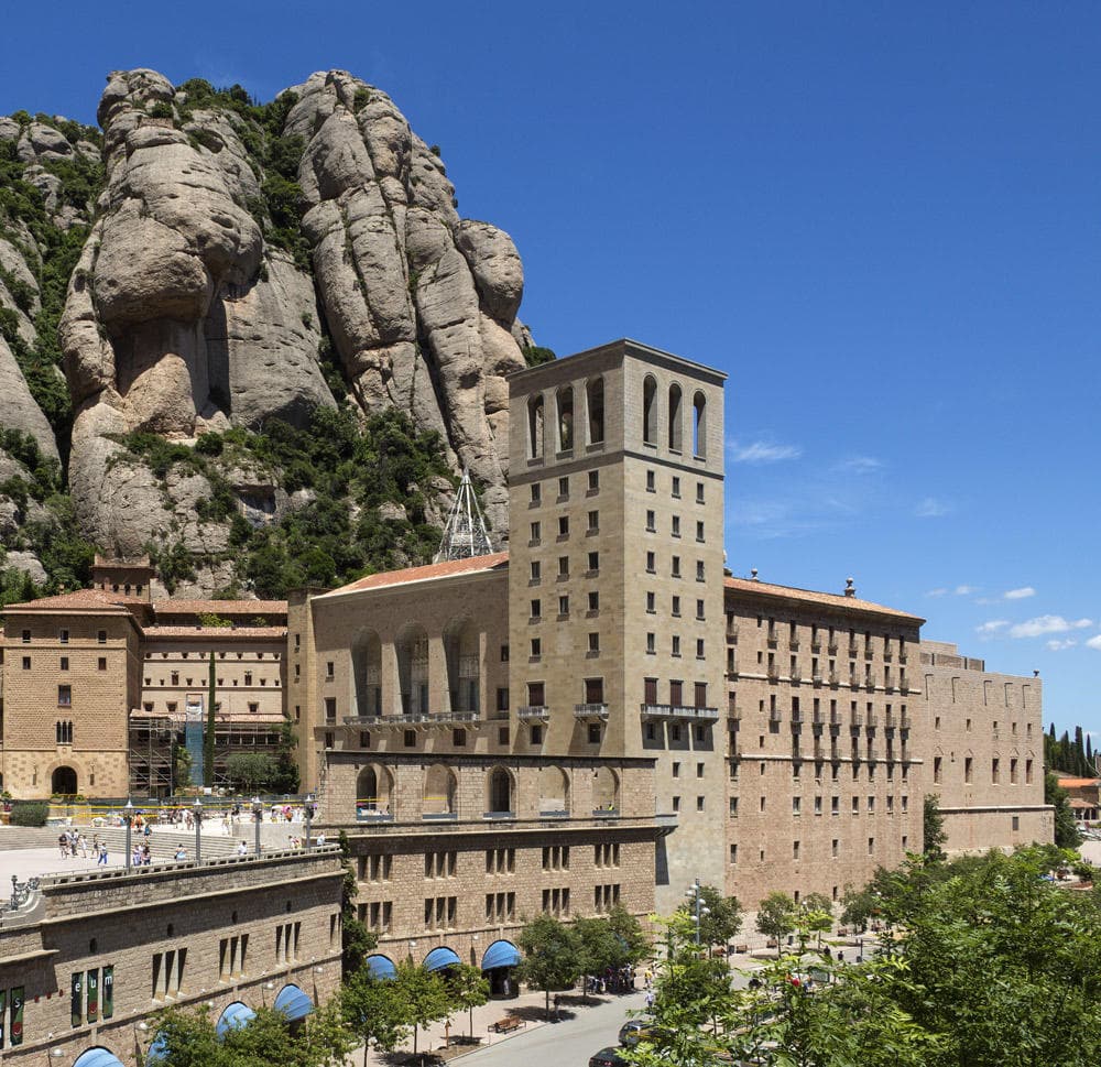 Montserrat monastery complex against steep cliffs, cultural hiking site