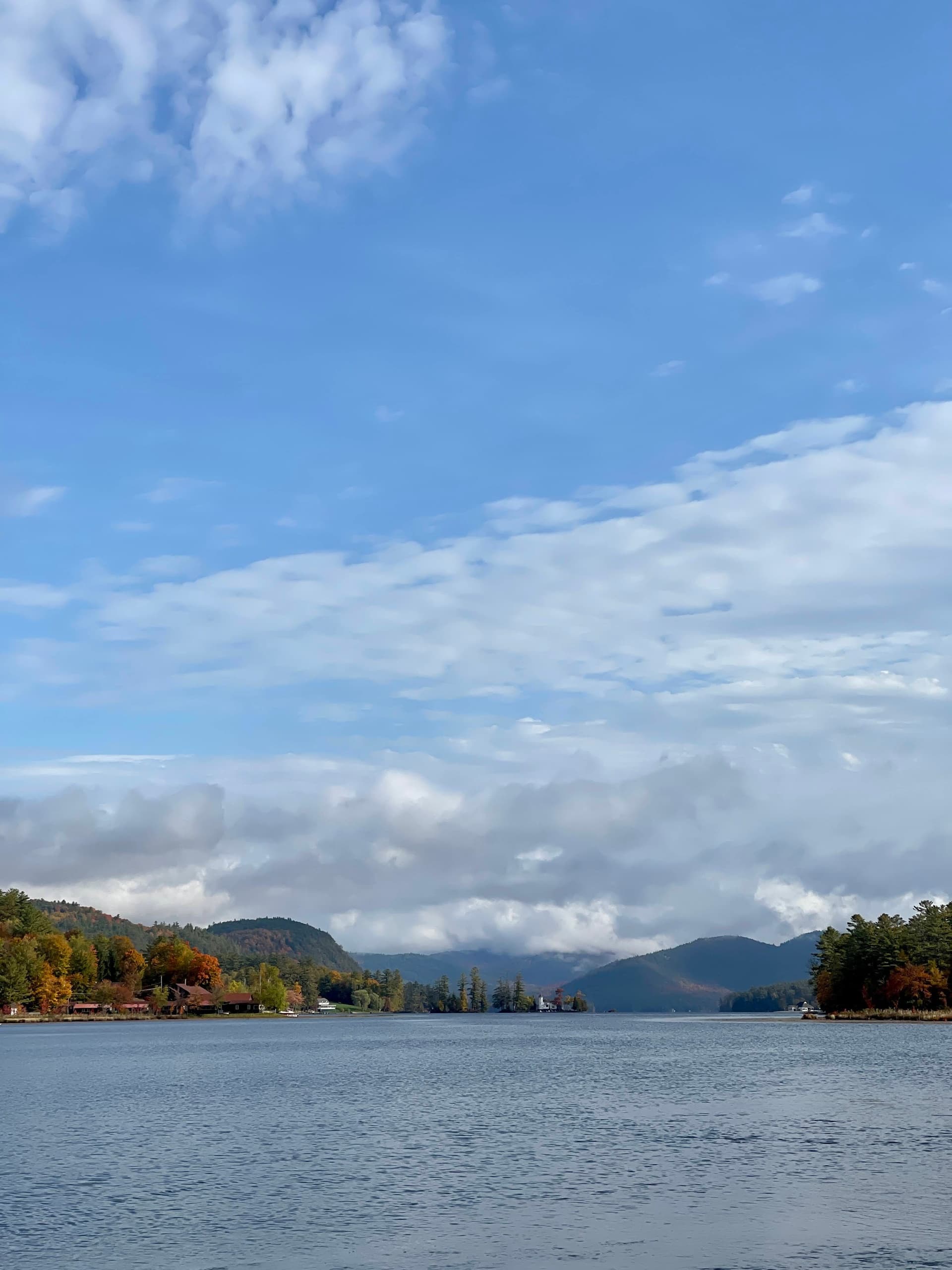 Long vertical lake vista at Brant Lake with islands and sky