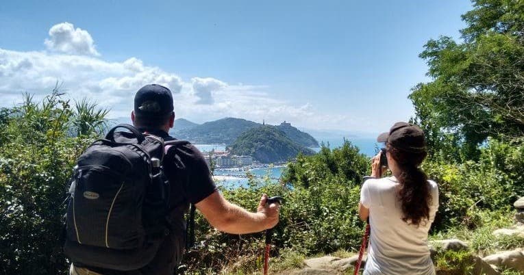Hikers overlooking coastal island vista in San Sebastián hike
