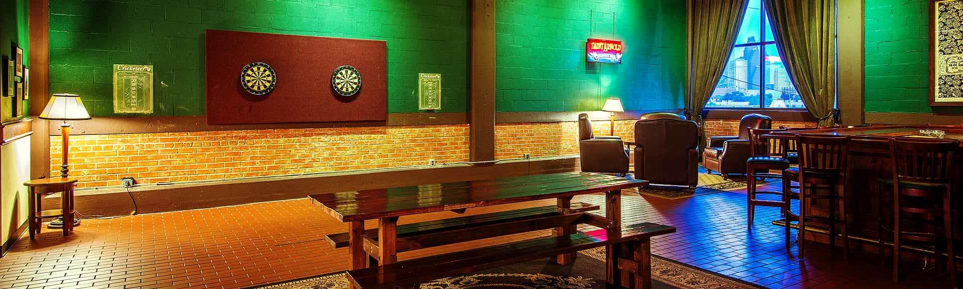 Cozy taproom seating and warm lighting inside Saint Arnold pub