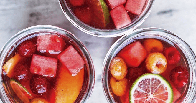 Fruit cocktails in jars for outdoor picnic or summer rooftop