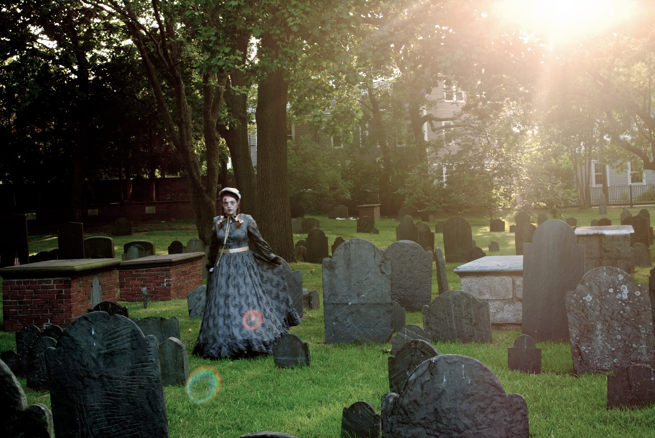 Solitary guide amid historic graveyard during golden hour in Cambridge