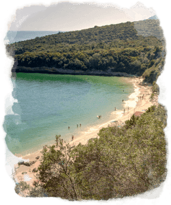 Secluded sandy beach cove with cliffs, Atlantic coastal swimming