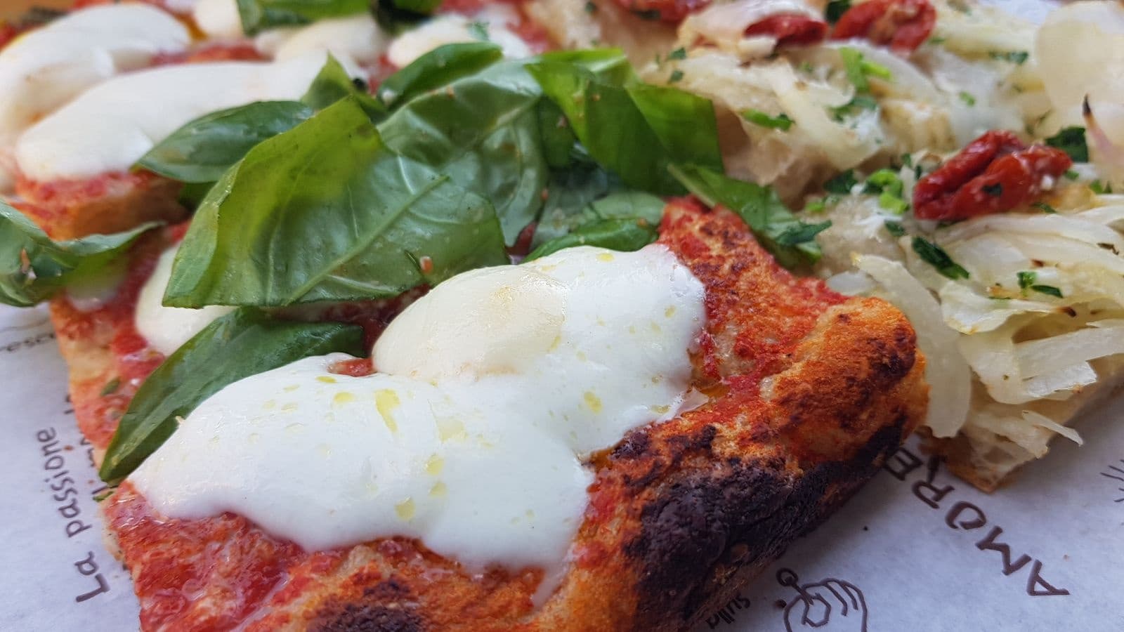 Close-up margherita pizza slice with fresh mozzarella and basil, Rome