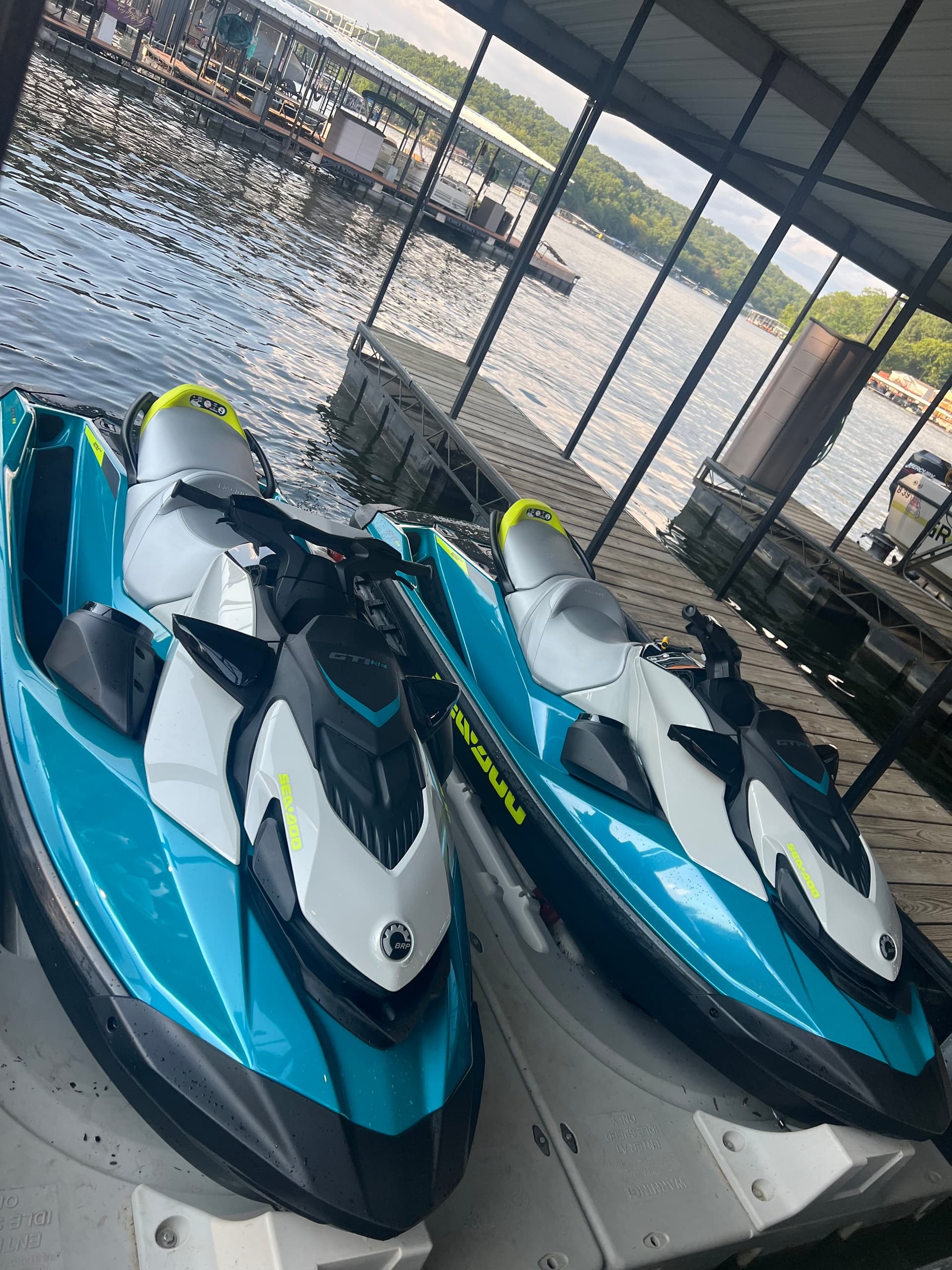 Two jet skis docked at marina ready for thrilling lake rides