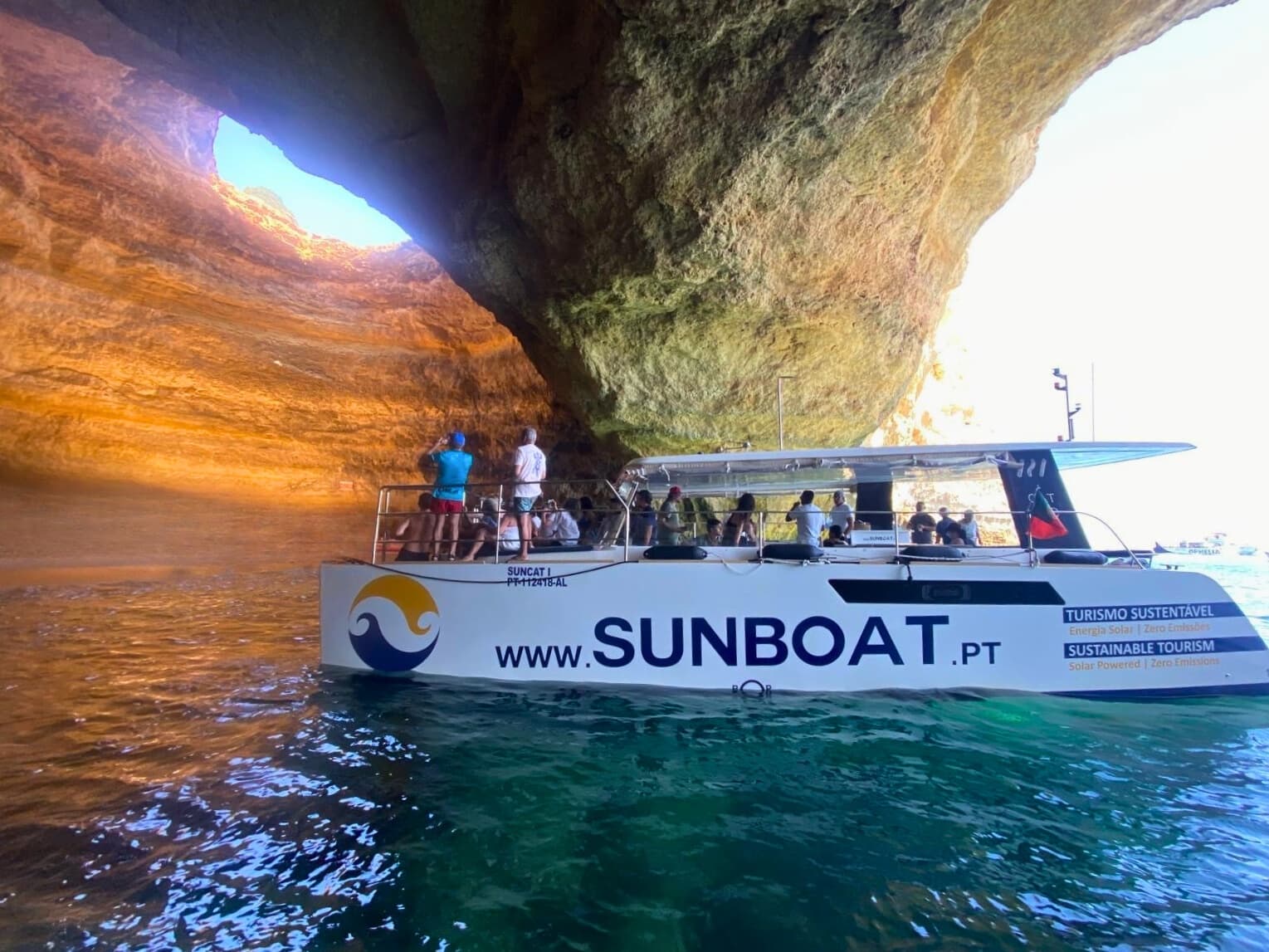 Coastal cave boat tour entering sea cave on guided cruise