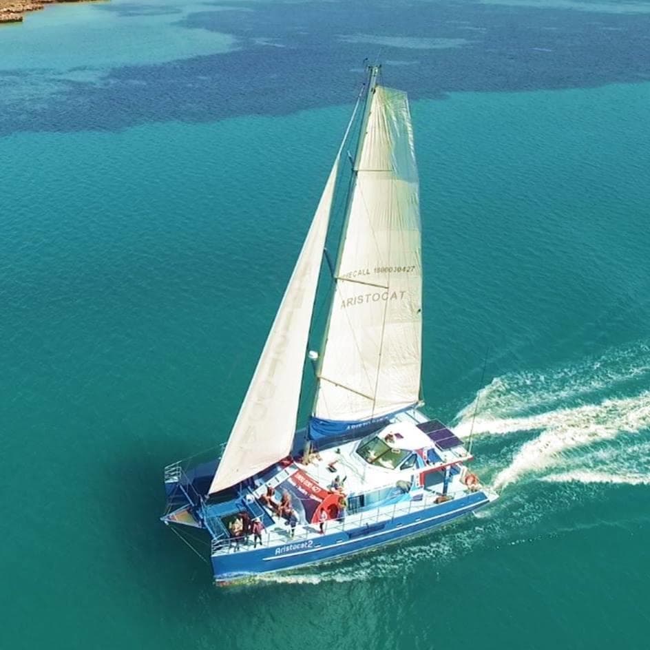 Sailboat cruising turquoise ocean for scenic island tours