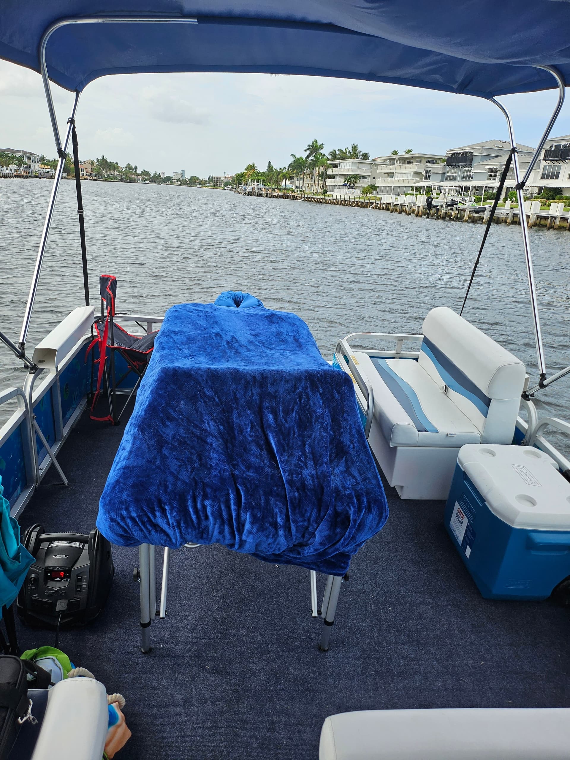 Massage setup on pontoon boat deck with waterfront view