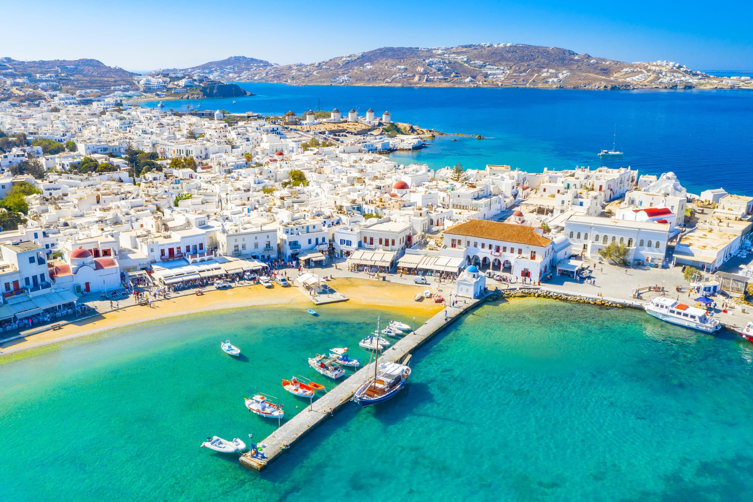 Aerial harbor and pier with turquoise water, island coastal cruise