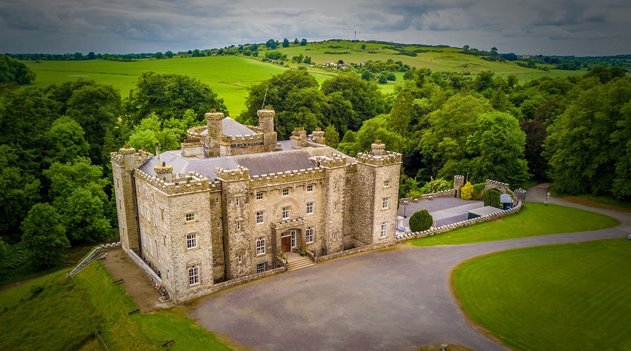 Aerial view of historic Irish castle amid green countryside
