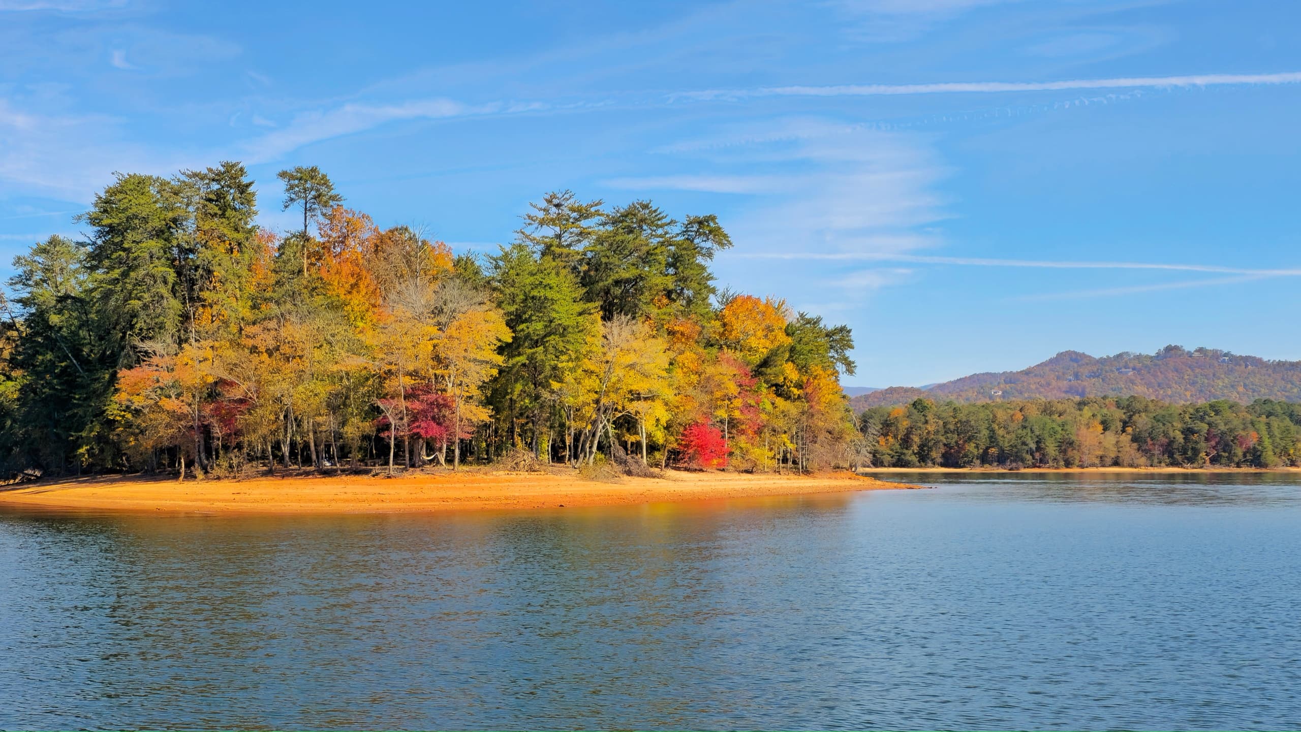 Autumn tree-covered island on Lake Chatuge with calm waters