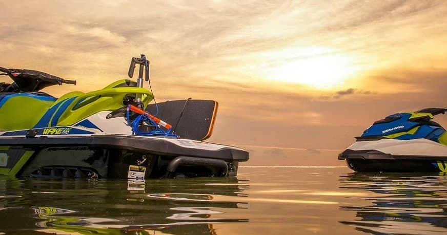 Close-up twin jet skis at sunset on calm coastal waters, Comox