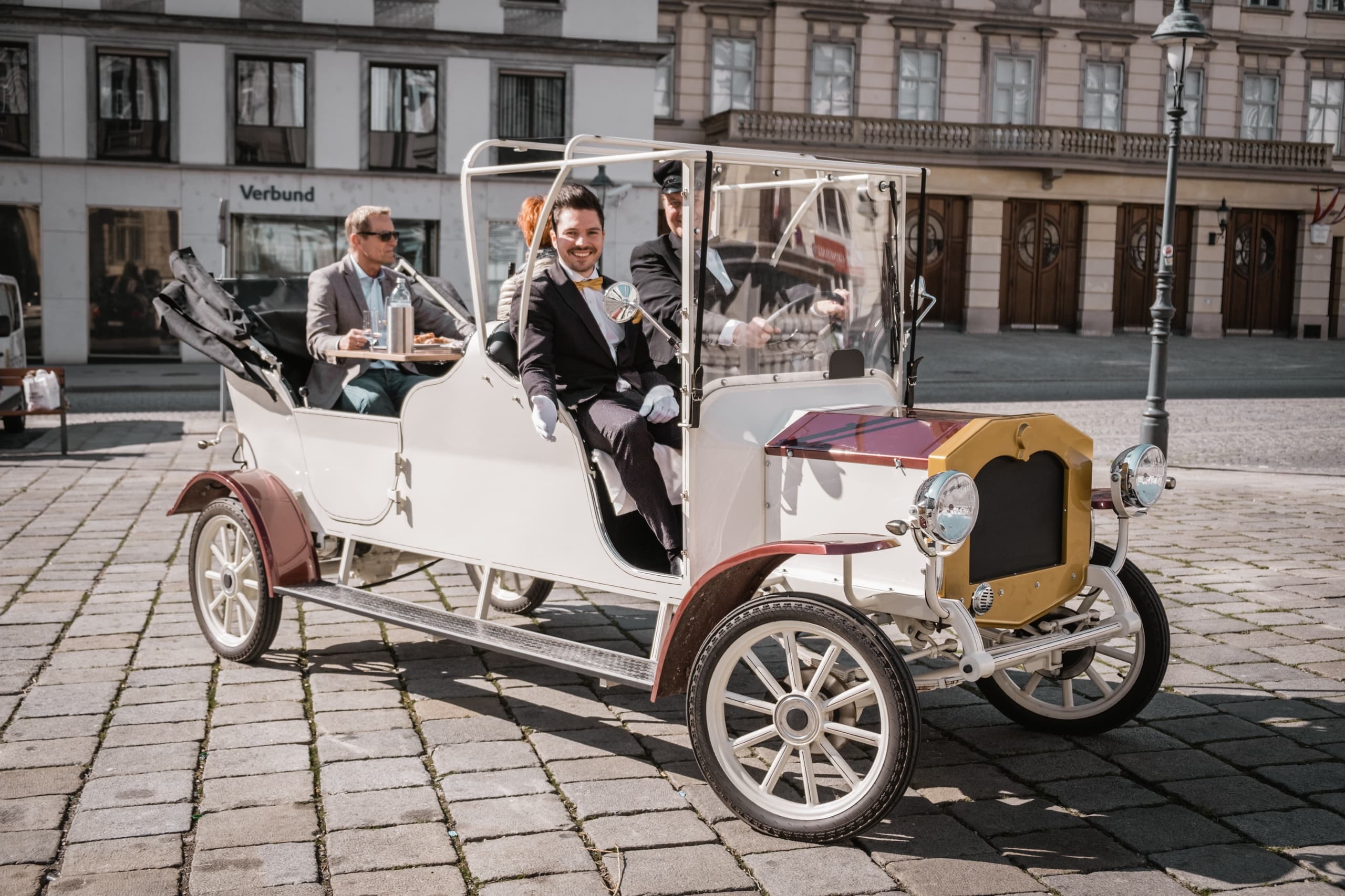 Vintage car tour parked in grand European palace square outdoors