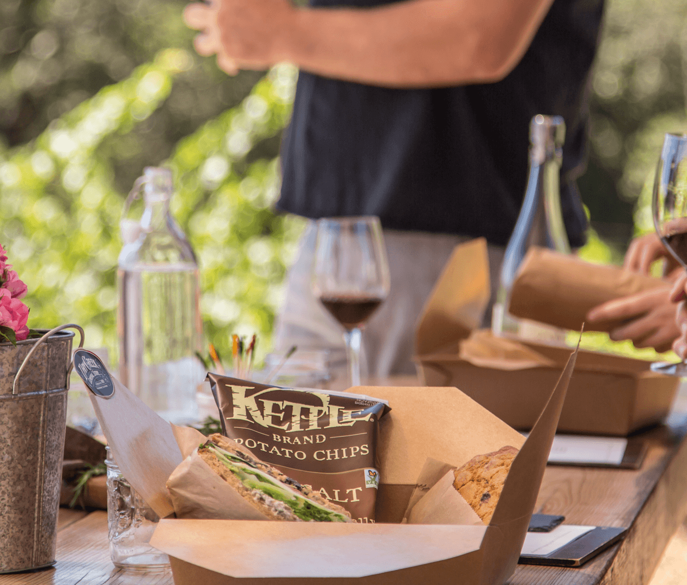 Outdoor wine picnic with glasses and gourmet snacks on patio