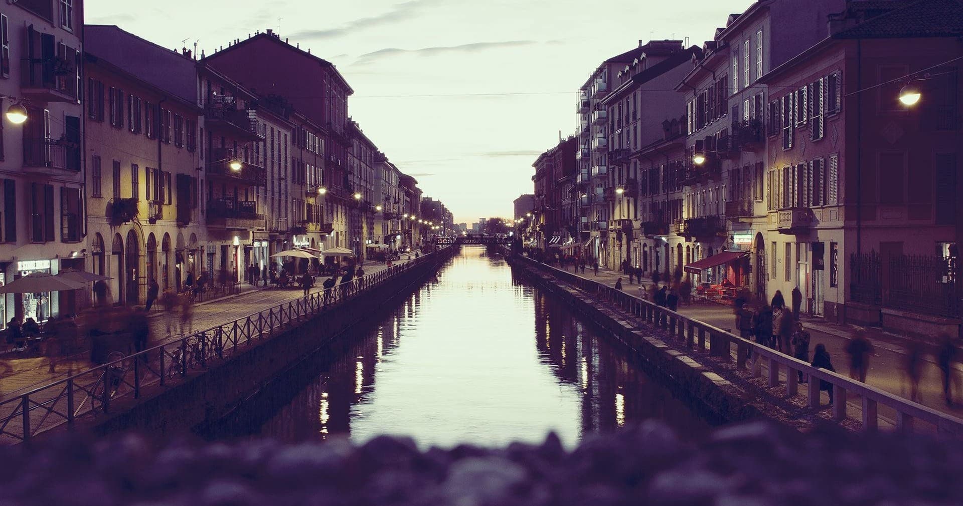 Evening canal view with bridges and city lights, urban waterscape tour