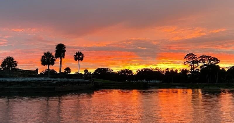 Sunset over St. Augustine waterfront with palm silhouettes
